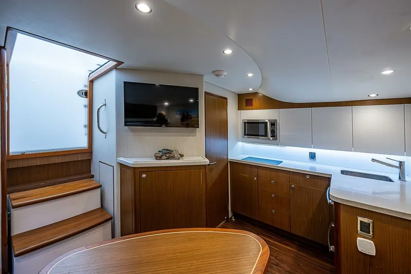 Big Hit Yacht Photos Pics Luxurious 2020 Cabo 41 Express yacht interior with modern kitchen and entertainment area.