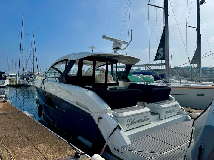 Determination Yacht Photos Pics 2020 Cruisers Yachts 39 Express Coupe docked at marina under clear blue sky.