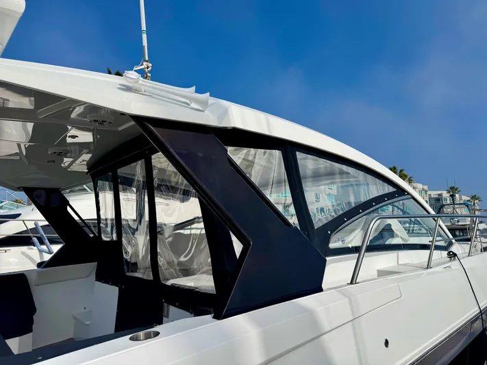 Determination Yacht Photos Pics 2020 Cruisers Yachts 39 Express Coupe, sleek design, docked under clear blue sky.