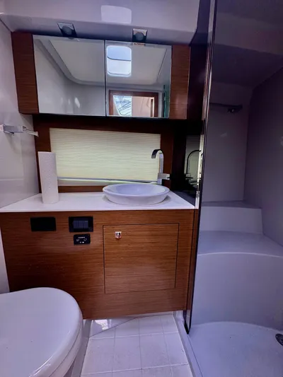Determination Yacht Photos Pics 2020 Cruisers Yachts 39 Express Coupe bathroom with modern fixtures and wood accents.