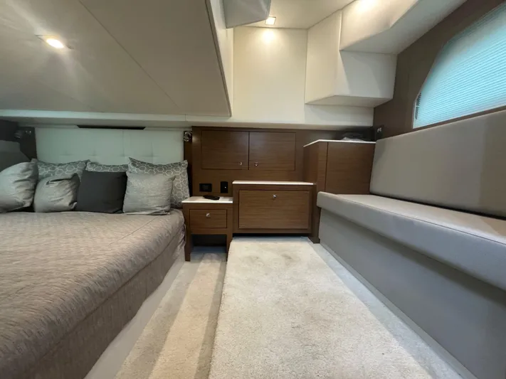 Determination Yacht Photos Pics 2020 Cruisers Yachts 39 Express Coupe interior with bed, seating, and wooden cabinetry.