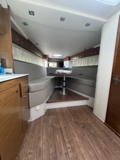 Determination Yacht Photos Pics Interior of 2020 Cruisers Yachts 39 Express Coupe with modern seating and wooden finishes.