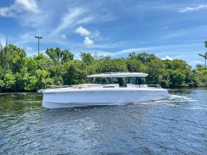  Yacht Photos Pics 2024 Axopar 45 XC Cross Cabin boat cruising on a sunny day.