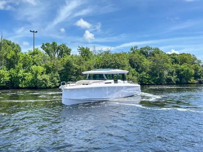 Yacht Photos Pics 2024 Axopar 45 XC Cross Cabin boat cruising on a sunny day.