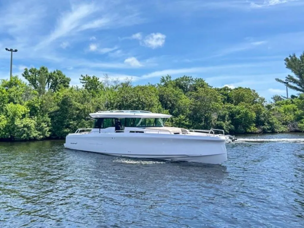 2024 Axopar 45 XC Cross Cabin boat cruising on a scenic waterway.