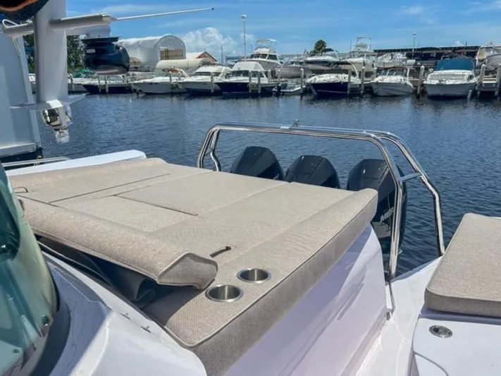  Yacht Photos Pics 2024 Axopar 45 XC Cross Cabin boat with sun deck and marina view.