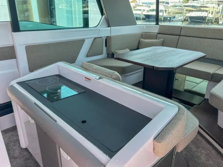  Yacht Photos Pics 2024 Axopar 45 XC Cross Cabin interior with seating and table.