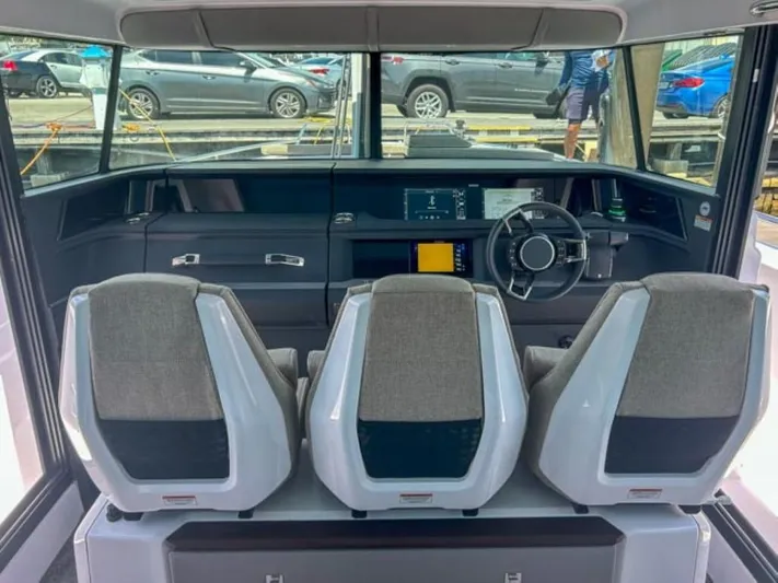  Yacht Photos Pics 2024 Axopar 45 XC Cross Cabin interior with three seats and modern dashboard.