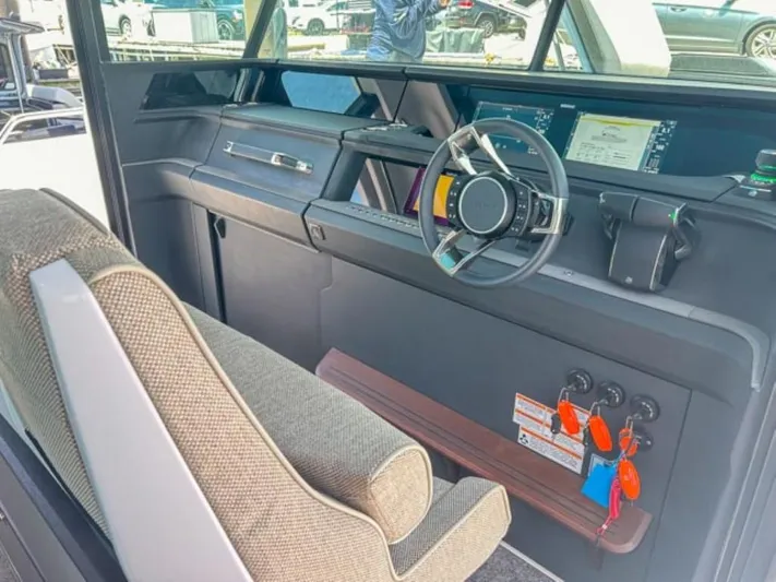  Yacht Photos Pics 2024 Axopar 45 XC Cross Cabin interior with modern steering and dashboard controls.