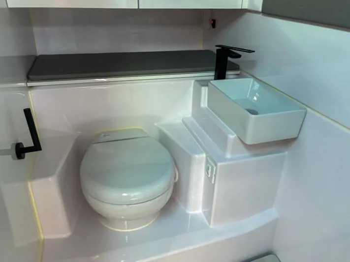  Yacht Photos Pics 2024 Axopar 45 XC Cross Cabin bathroom with modern toilet and sink.