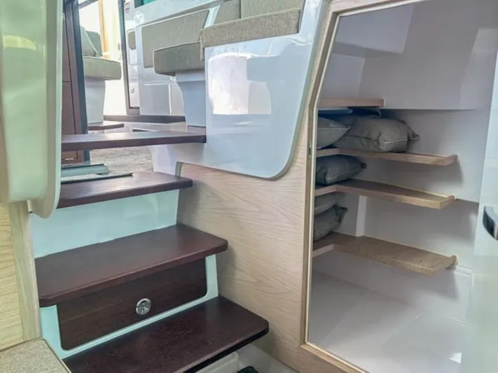  Yacht Photos Pics Interior of 2024 Axopar 45 XC Cross Cabin with wooden steps and storage shelves.