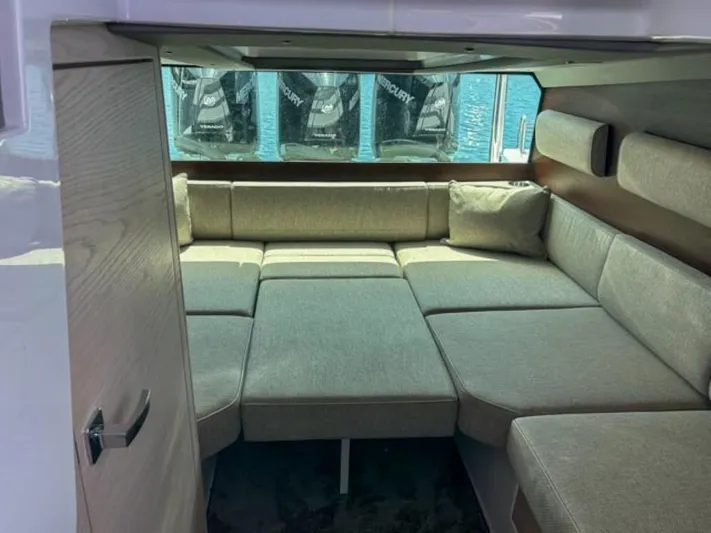 Yacht Photos Pics 2024 Axopar 45 XC Cross Cabin interior with cozy seating and window view.