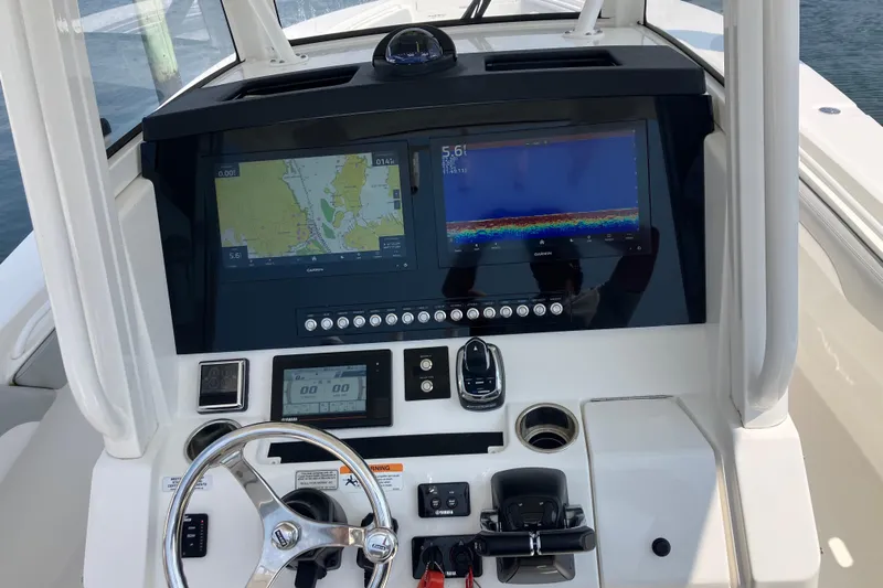  Yacht Photos Pics 2020 Regulator 31 boat dashboard with navigation screens and steering wheel.