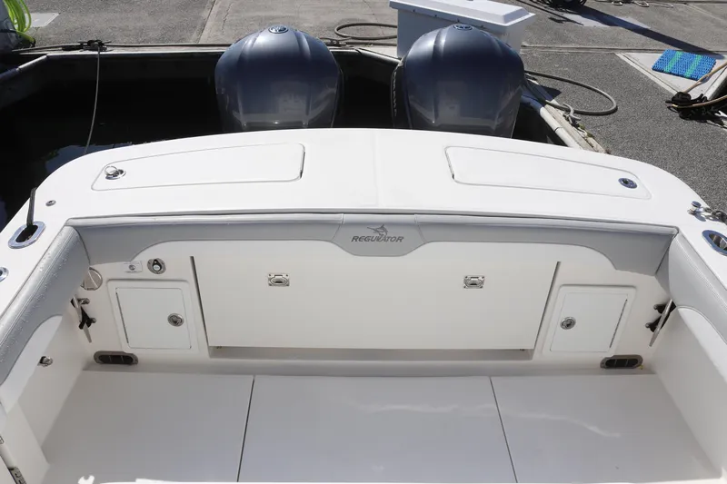  Yacht Photos Pics 2020 Regulator 31 boat stern with dual outboard engines and storage compartments.