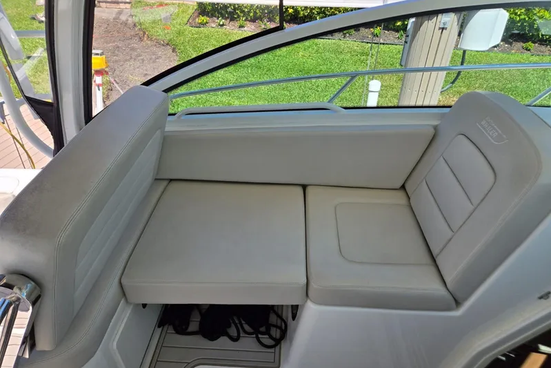  Yacht Photos Pics 2016 Boston Whaler 315 Conquest interior seating, featuring comfortable beige upholstery.