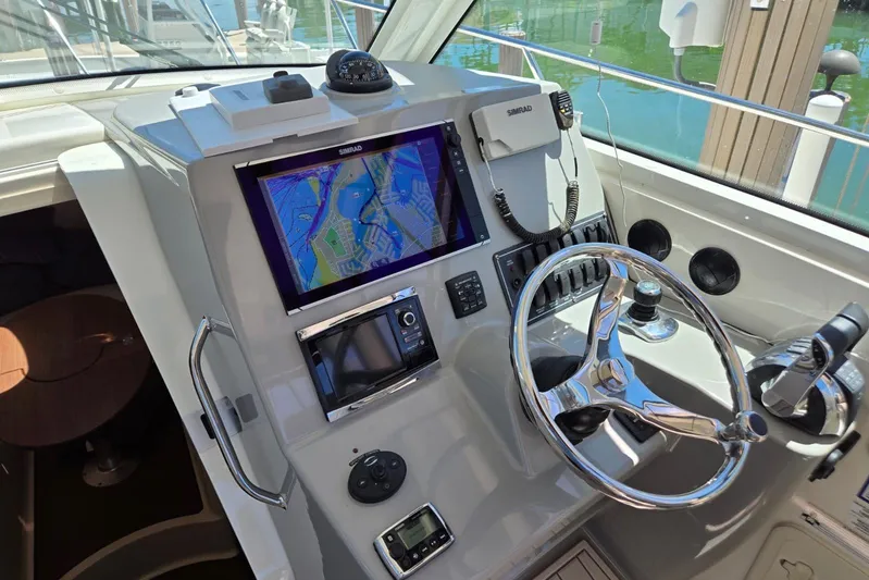  Yacht Photos Pics 2016 Boston Whaler 315 Conquest helm with navigation system and controls.