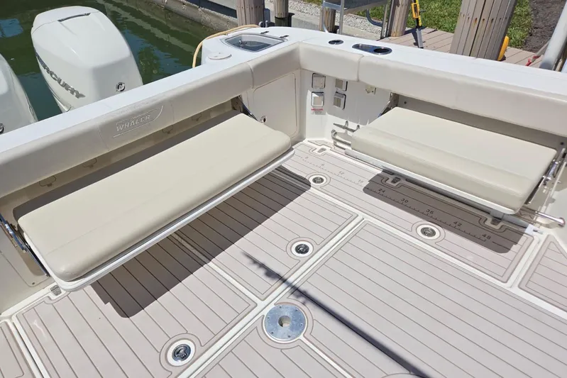 Yacht Photos Pics 2016 Boston Whaler 315 Conquest boat deck with foldable seating and clean design.