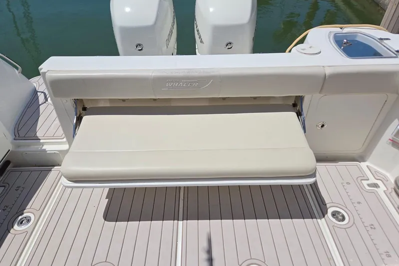  Yacht Photos Pics 2016 Boston Whaler 315 Conquest boat with foldable bench seat and twin engines.