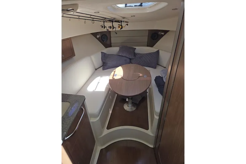  Yacht Photos Pics 2016 Boston Whaler 315 Conquest cabin interior with cozy seating and table.