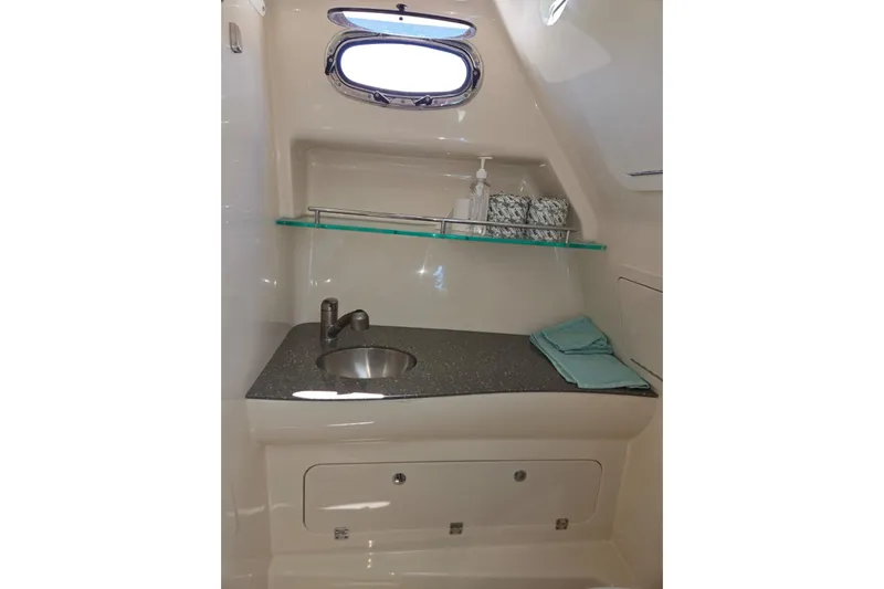  Yacht Photos Pics 2016 Boston Whaler 315 Conquest bathroom with sink, shelf, and window.