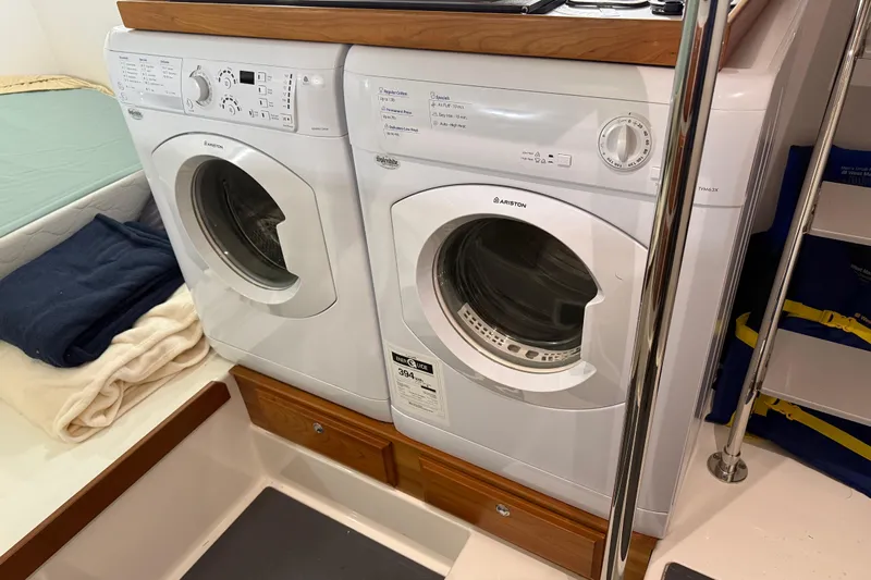 Oyster Yacht Photos Pics Laundry area with washer and dryer inside a 2018 Sabre 48 Salon Express yacht.