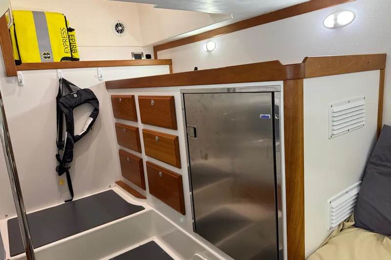 Oyster Yacht Photos Pics 2018 Sabre 48 Salon Express interior with storage drawers and stainless steel fridge.