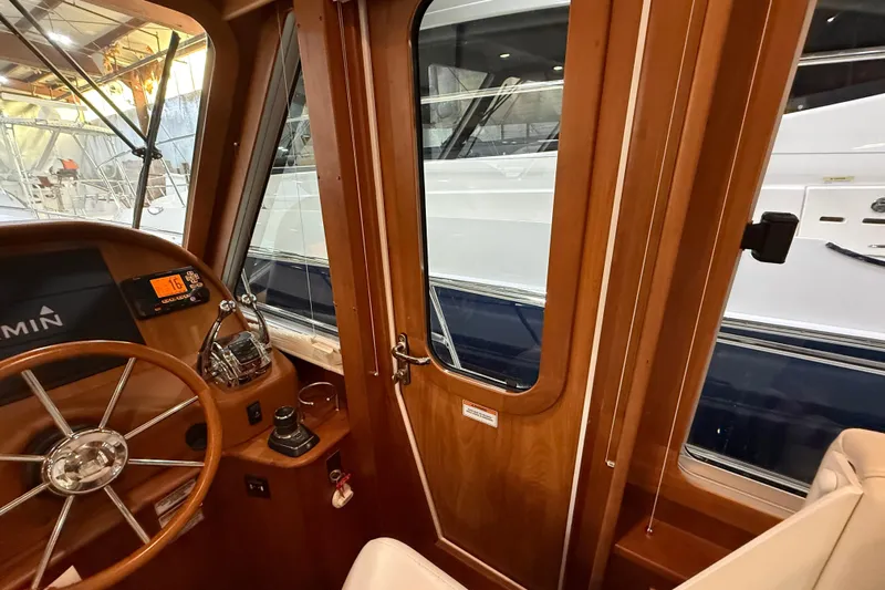 Oyster Yacht Photos Pics Interior view of 2018 Sabre 48 Salon Express yacht helm with wooden finish.