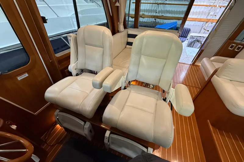 Oyster Yacht Photos Pics Interior of 2018 Sabre 48 Salon Express with plush white seating and wooden flooring.