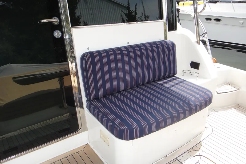Oyster Yacht Photos Pics Striped seating on 2018 Sabre 48 SE yacht deck, featuring sleek design and comfort.