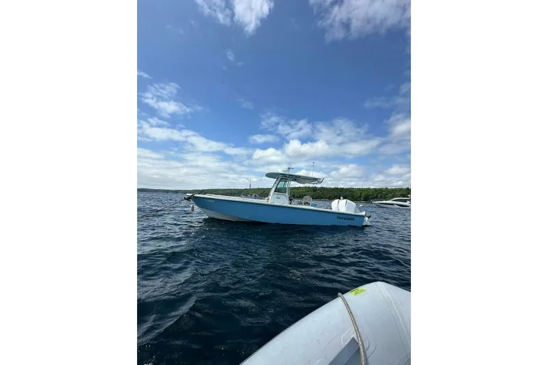  Yacht Photos Pics 2019 Everglades 273 Center Console boat on open water under blue sky.