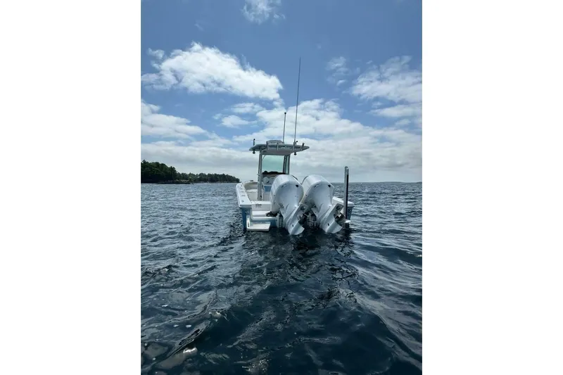  Yacht Photos Pics 2019 Everglades 273 Center Console boat on open water under a partly cloudy sky.