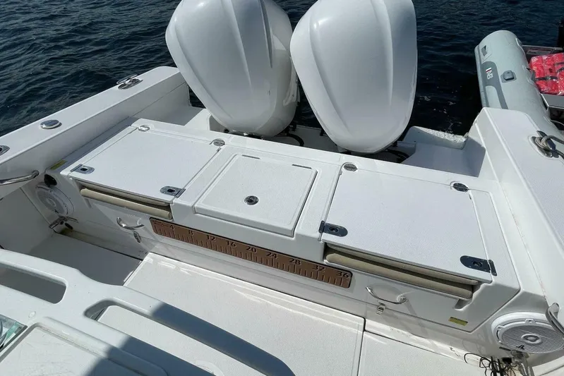  Yacht Photos Pics 2019 Everglades 273 Center Console boat with dual engines and storage compartments.