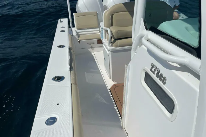  Yacht Photos Pics 2019 Everglades 273 Center Console boat on water, featuring sleek design and comfortable seating.