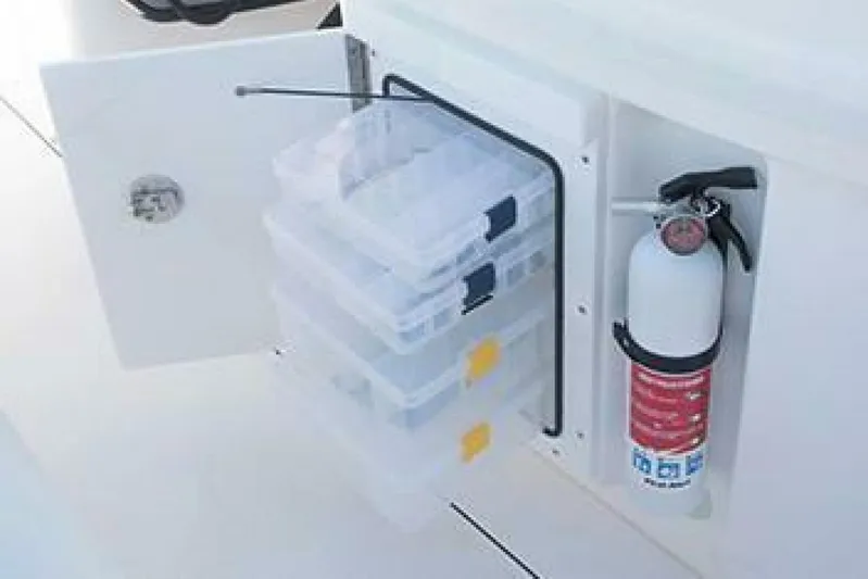  Yacht Photos Pics Storage compartment with tackle boxes and fire extinguisher on 2019 Everglades 273 Center Console boat.