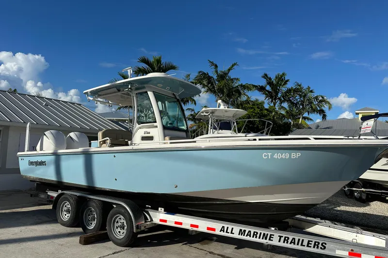  Yacht Photos Pics 2019 Everglades 273 Center Console boat on trailer, parked outdoors under clear sky.
