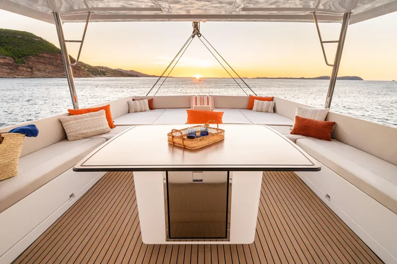  Yacht Photos Pics Luxurious Bali 5.8 yacht interior with sunset view, 2026 model, featuring elegant seating and table.