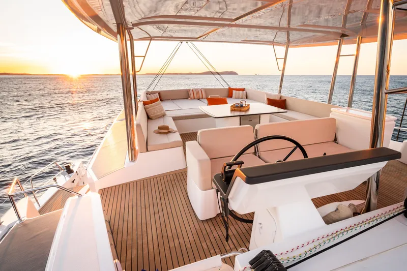  Yacht Photos Pics Luxurious Bali 5.8 yacht deck at sunset, featuring elegant seating and ocean views, 2026 model.