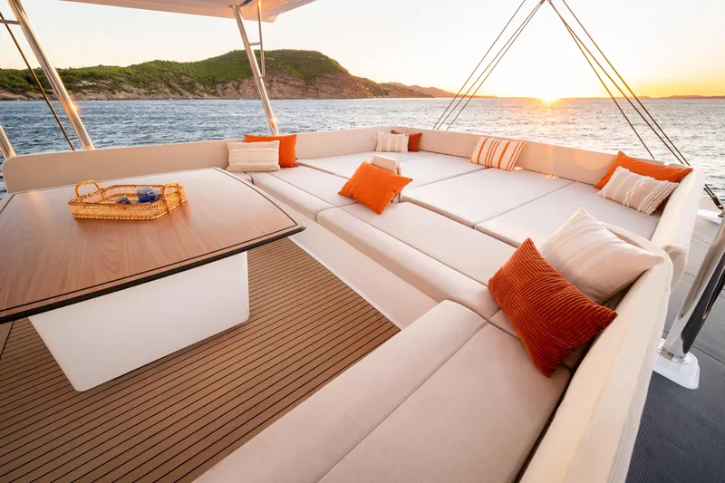  Yacht Photos Pics Luxurious Bali 5.8 yacht deck with sunset view, featuring elegant seating and cushions, 2026 model.