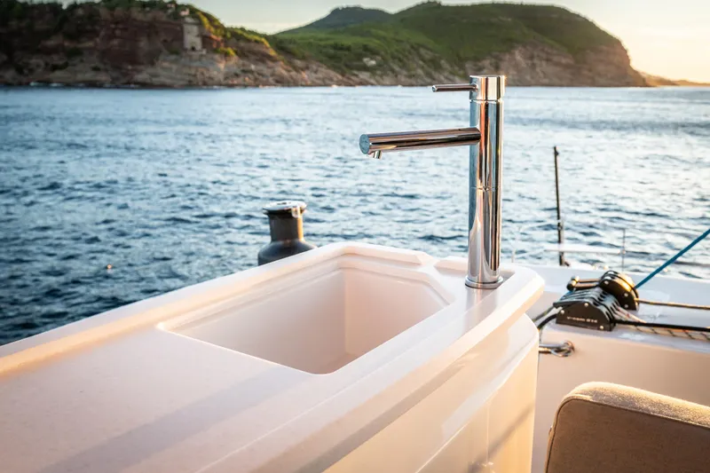  Yacht Photos Pics Outdoor sink on Bali 5.8 yacht, 2026 model, with ocean and cliffs in background.