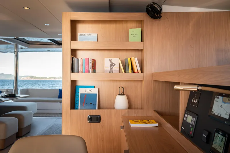  Yacht Photos Pics Luxurious Bali 5.8 yacht interior with wooden bookshelf, modern decor, and ocean view, 2026 model.