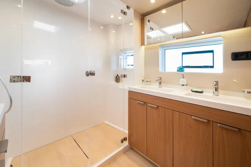  Yacht Photos Pics Modern bathroom in 2026 Bali 5.8 model yacht with dual sinks and glass shower.