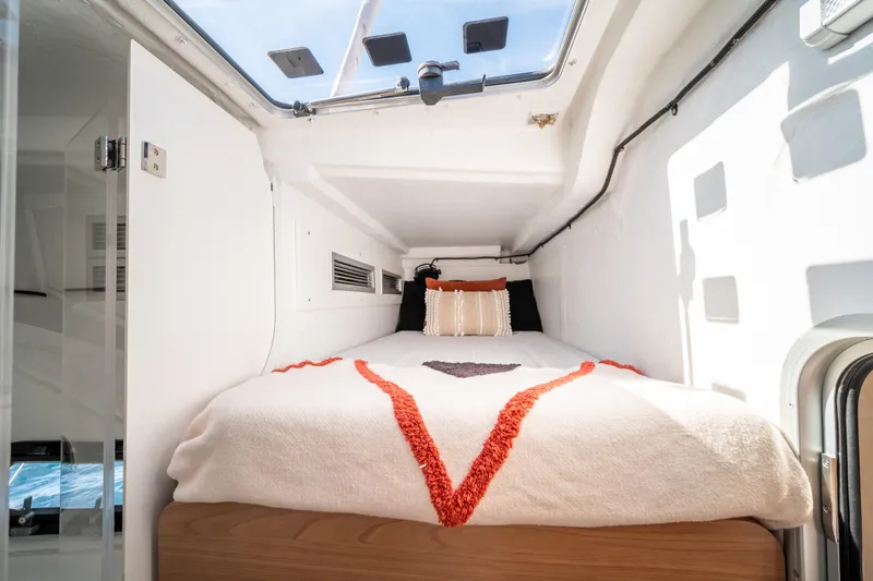  Yacht Photos Pics Compact cabin interior of 2026 Bali 5.8 yacht with cozy bed and skylight.