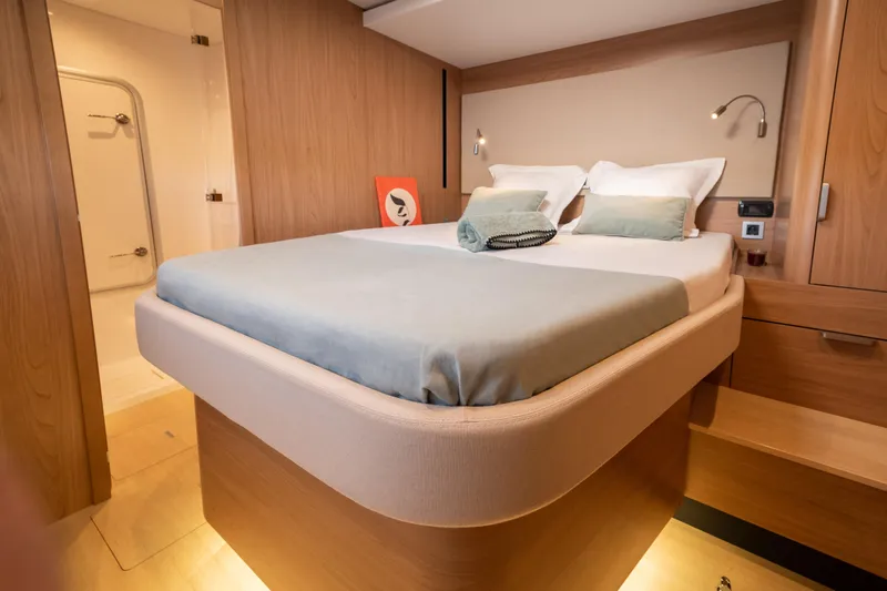  Yacht Photos Pics Luxurious bedroom interior of 2026 Bali 5.8 yacht with modern design and cozy bedding.