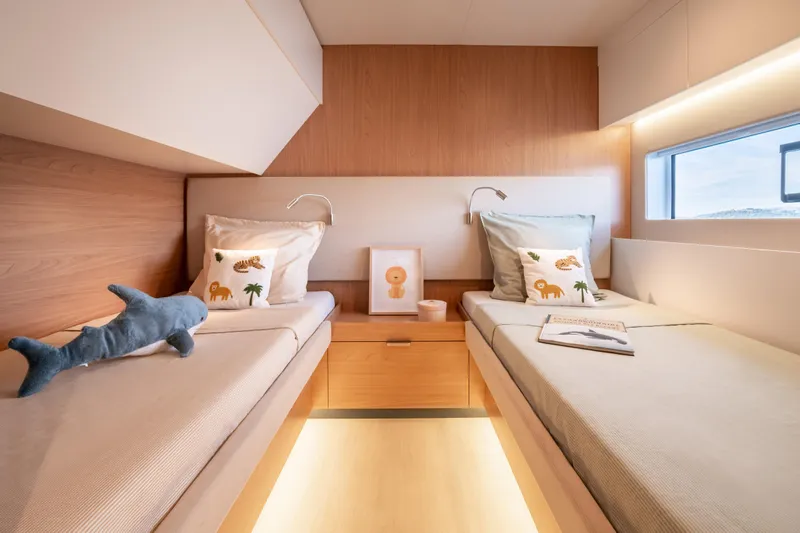  Yacht Photos Pics Modern twin cabin interior in 2026 Bali 5.8 yacht, featuring cozy beds and decorative pillows.