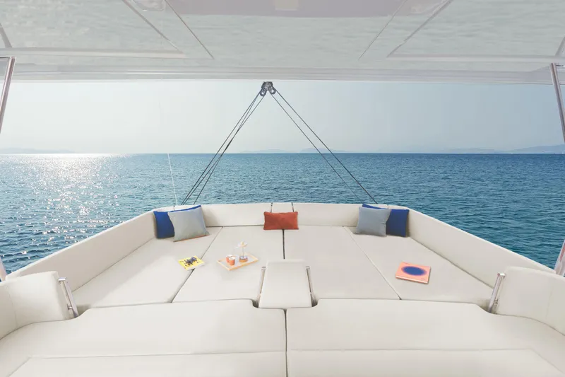  Yacht Photos Pics Luxurious Bali 5.8 yacht deck with cushions, overlooking serene ocean, 2026 model.