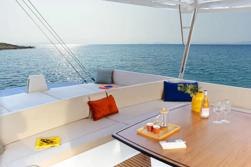  Yacht Photos Pics Luxurious Bali 5.8 yacht deck with ocean view, cozy seating, and elegant table setup, 2026 model.