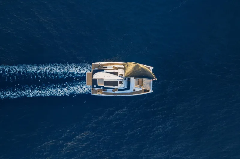  Yacht Photos Pics Aerial view of 2026 Bali 5.8 catamaran sailing on deep blue ocean.