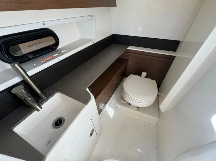  Yacht Photos Pics 2020 Sea Ray SDX 290 Outboard boat interior bathroom with sink and toilet.