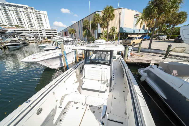  Yacht Photos Pics 2022 World Cat 400 CC-X boat docked at marina, sunny day, palm trees in background.