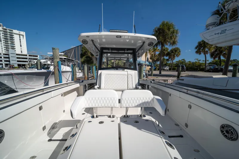  Yacht Photos Pics 2022 World Cat 400 CC-X boat interior with white seating, docked under clear blue sky.